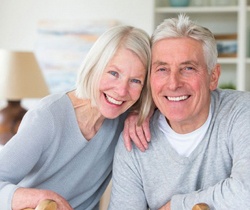 Smiling older couple with dental implants in State College