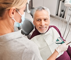 patient smiling while getting dentures in State College
