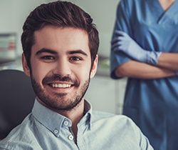 Smiling man in dental chair after cosmetic dental bonding treatment