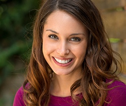 Woman with flawless healthy smile after porcelain veneers