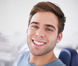 Smiling man in dental chair after cosmetic dental bonding