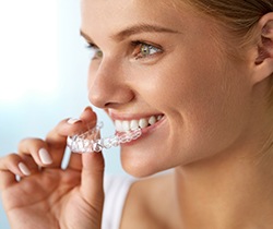 Woman placing ClearCorrect aligner