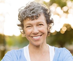 woman smiling while outside 