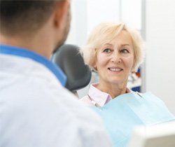 patient smiling while looking at dentist 