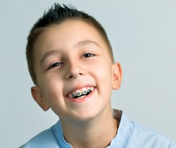 Young boy with braces, benefiting from myofunctional therapy