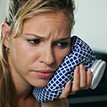 Woman holding ice pack to cheek before T M J therapy