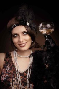 woman in 1920s smiling with champagne 