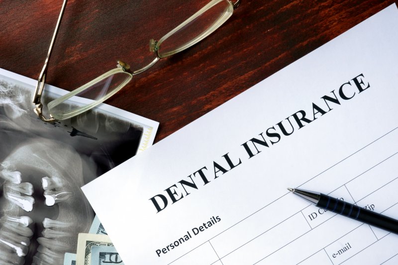 Dental insurance form on a crowded desk