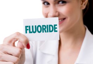 Dentist holding fluoride history card