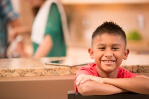 young boy with healthy smile thanks to children's dentistry 