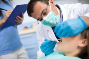 A dentist in State College performing an exam.